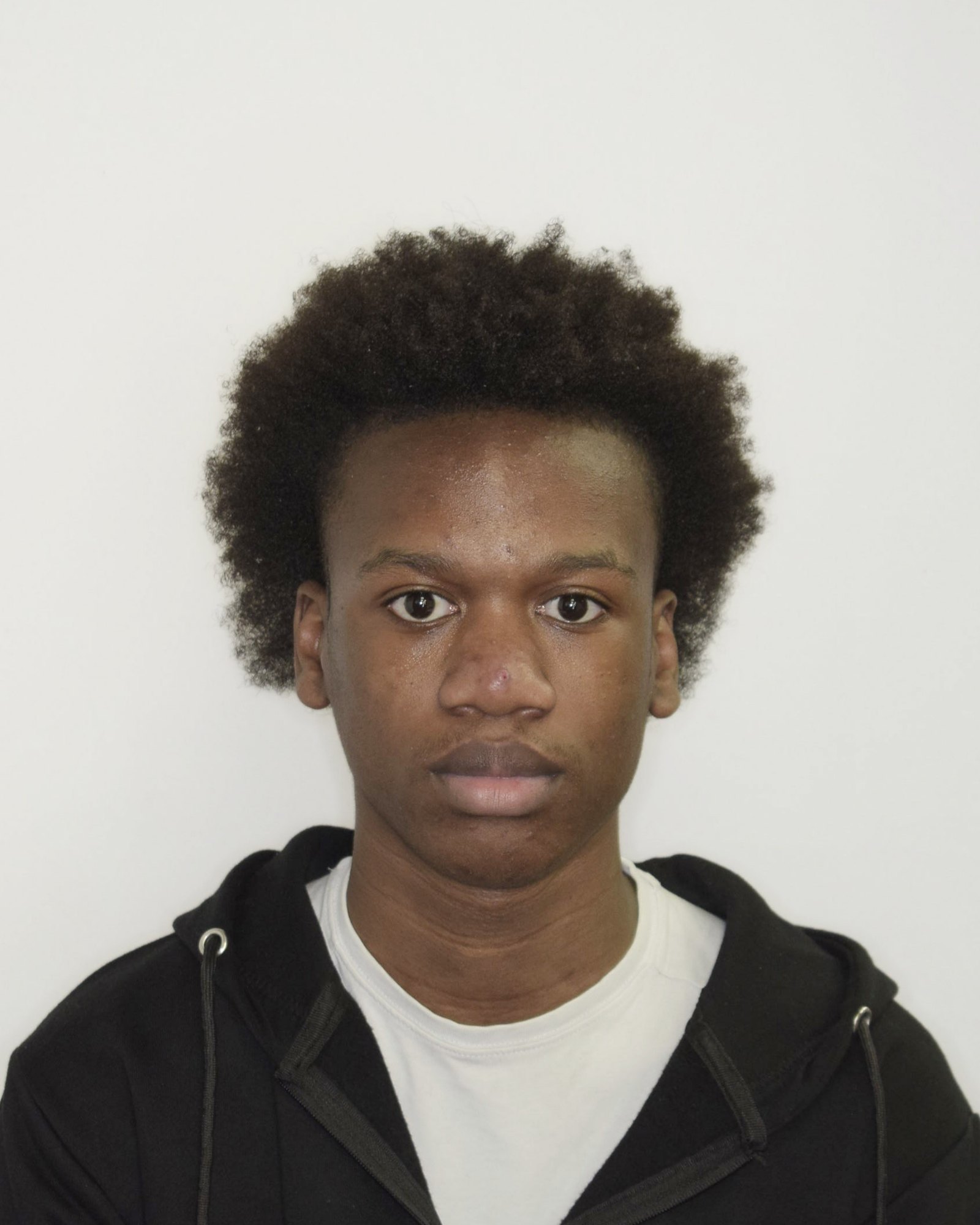 Front headshot, neutral, plain background