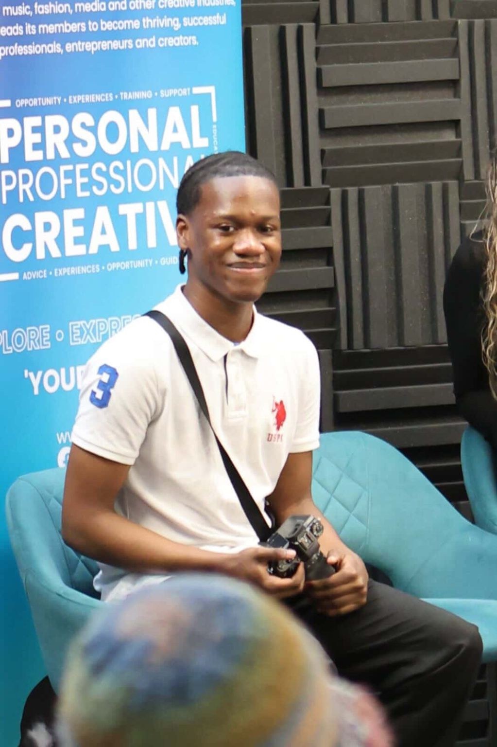 Smiling to camera at a creative industry panel